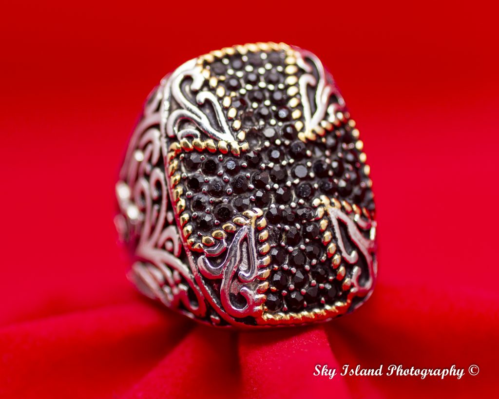 Mens sapphire ring on red setting with two stone missing. Sky Island photography John Heyward