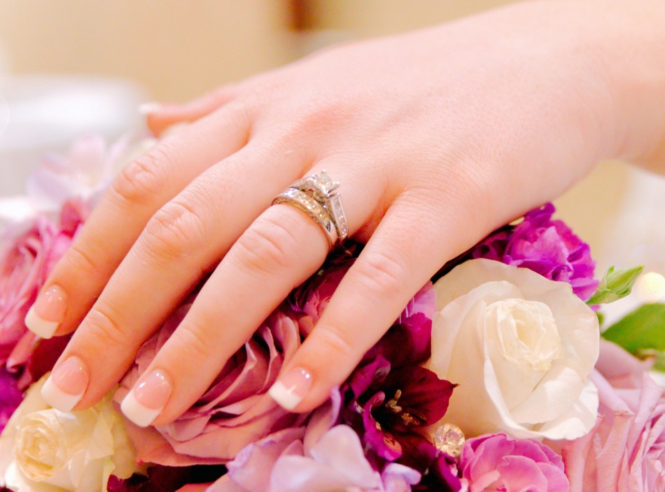 Wedding rings on brides hand wedding day across bouquet Sky Island Photography John Heyward