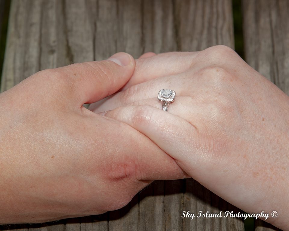 Holding hands with engagement ring Sky island photography captured by John Heyward